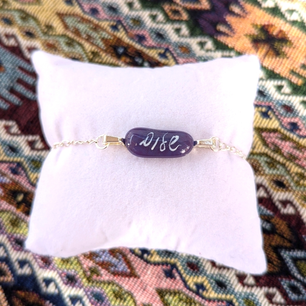 Hand crafted one of a kind purple glass Shalom/peaceful silver plated bracelet.